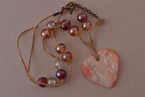 Necklace With A Shell Pendant And Glass Beads